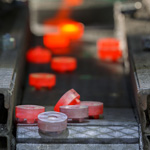 An electric arc furnace glows red as it heats steel above the melting point of 2500°F