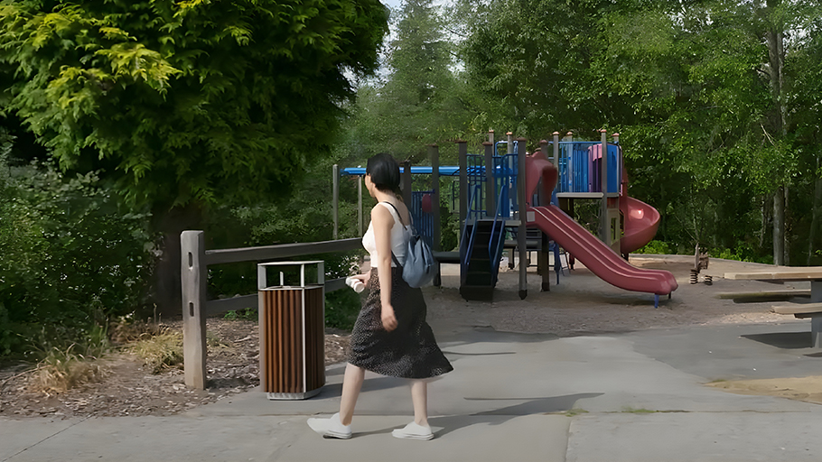 Reliance Foundry R-5001 Cincinnati waste bin utilized by a park visitor