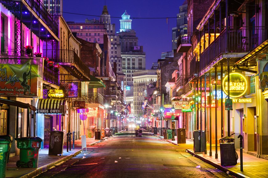 Bollards on downtown street with neon lights