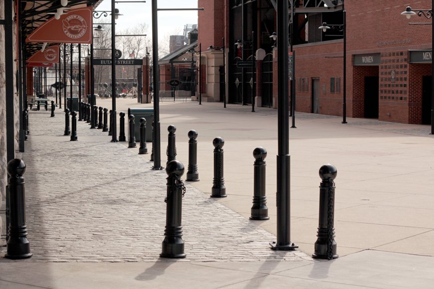 Small decorative bollards with lowered chains enhance area outside a club