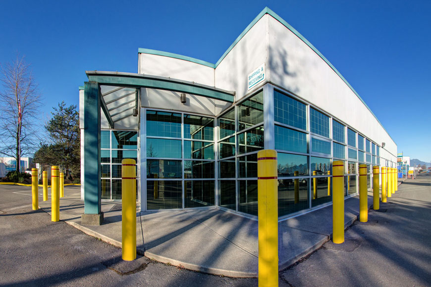 Yellow plastic covers with red reflective tape create a bright border around a building