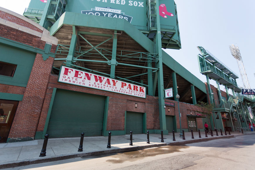 A row of round top black bollards protect Gate C at Fenway Park