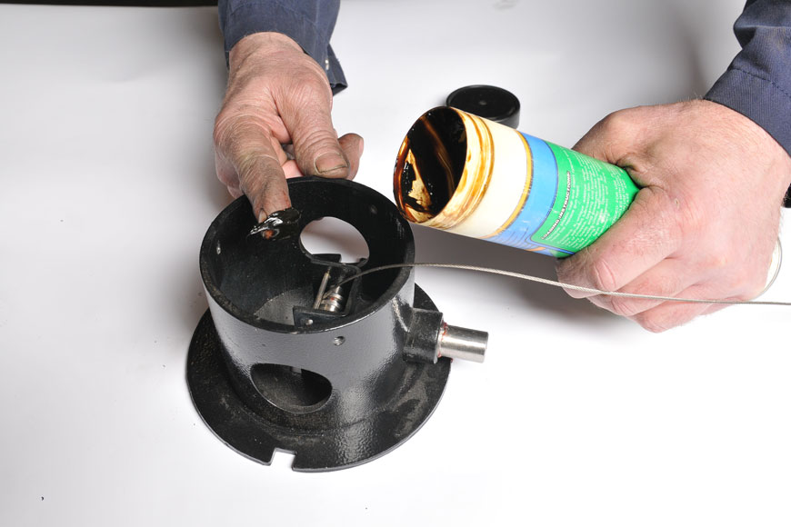 Assembly grease being applied to retractable bollard's internal mechanisms