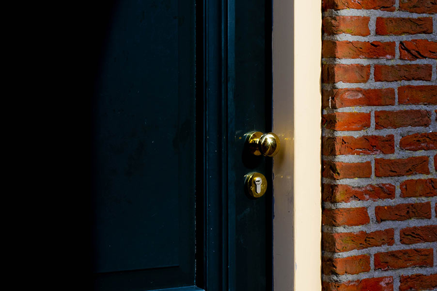 Brass handle on black door