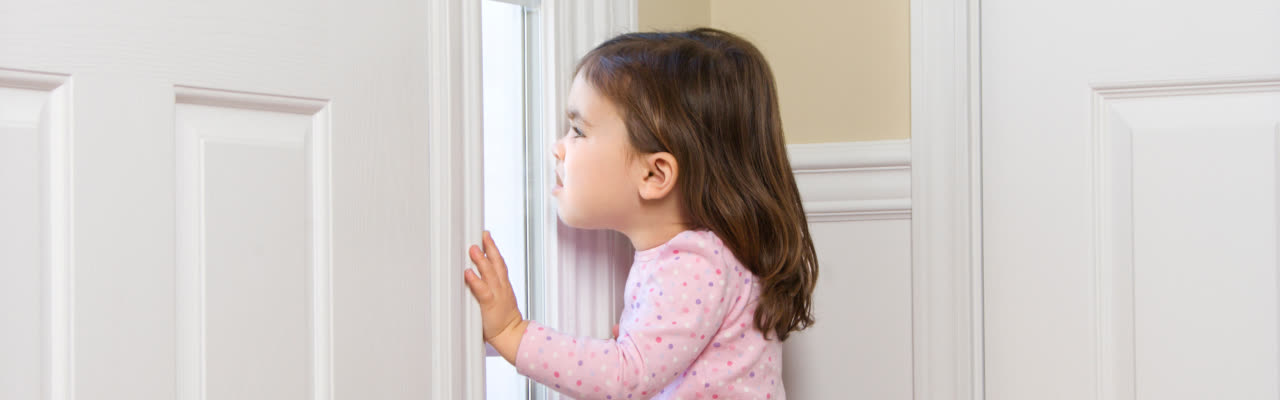 kid looking through the door