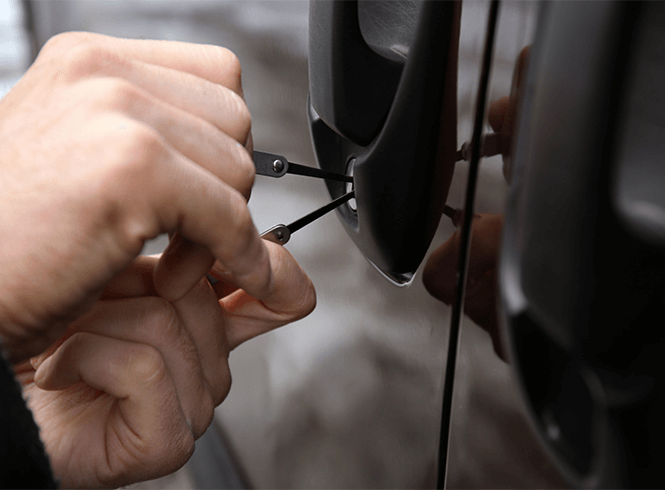 Locksmith picking a car lock